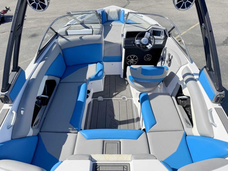 Slide: The Image of 2019 Tigé R21 boat interior with blue and gray seating, modern dashboard, and spacious layout. - 6
