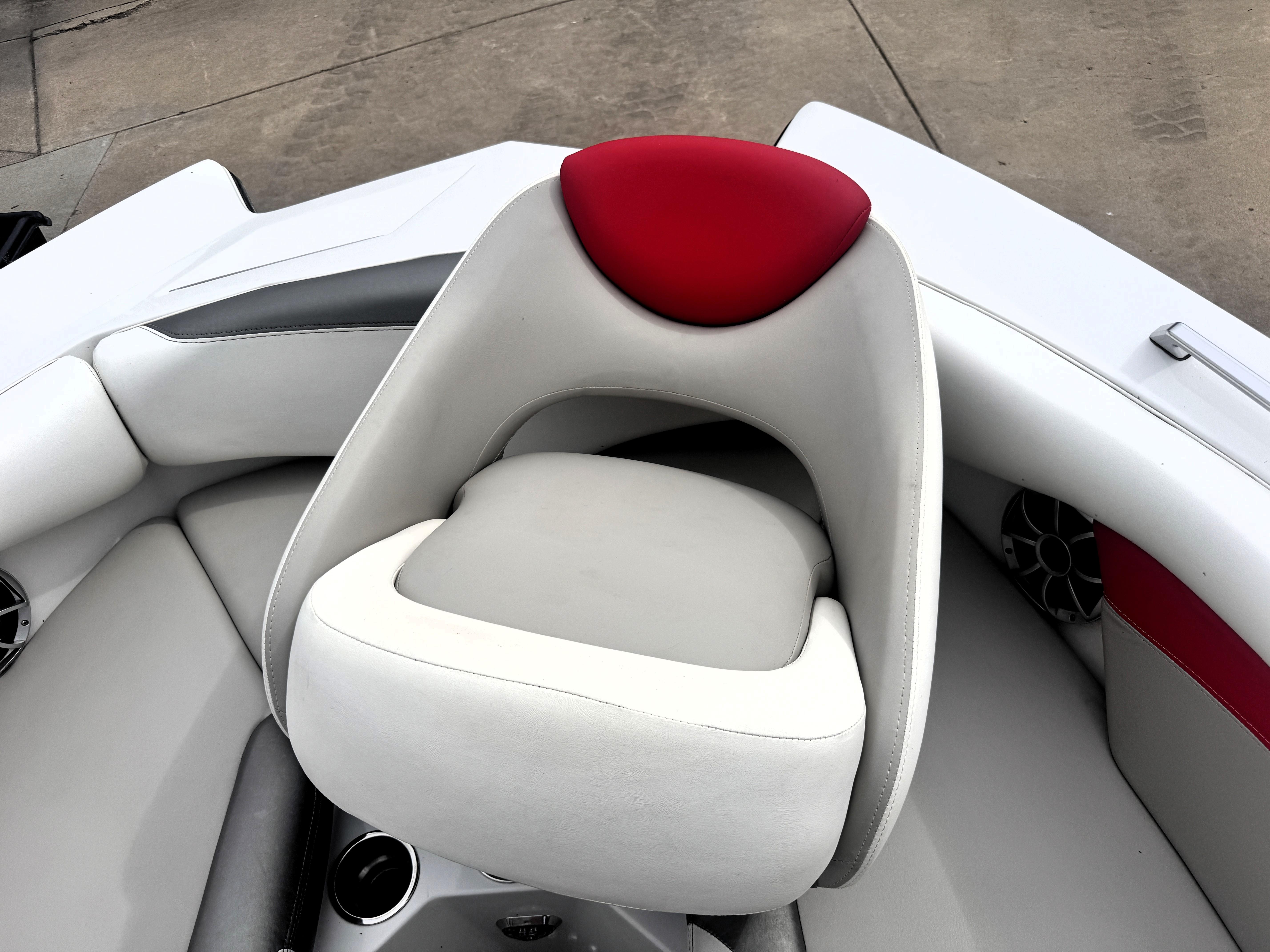 Slide: The Image of 2007 Tigé RZ2 boat interior with white and red seating, featuring cup holders and speakers. - 16