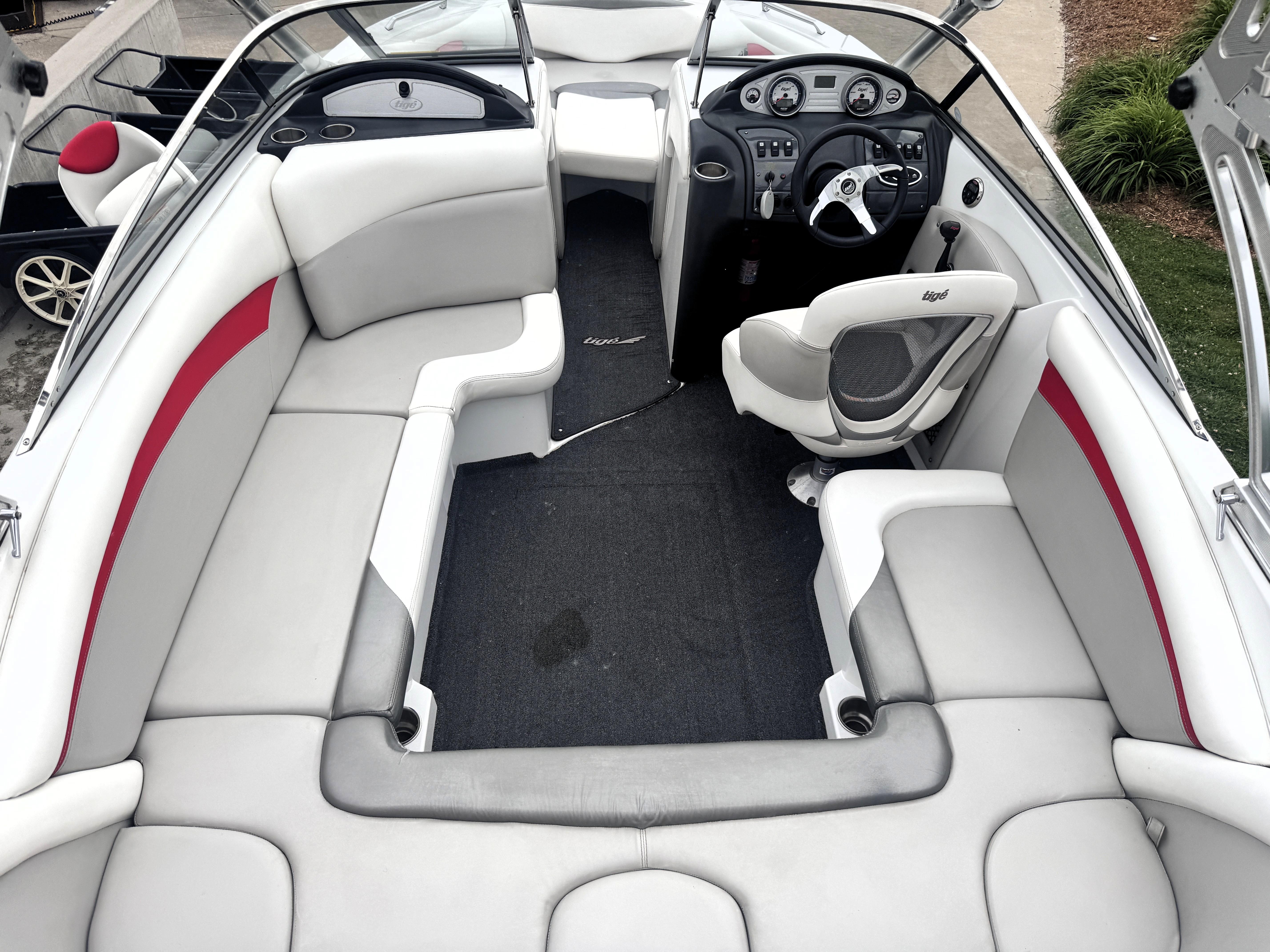 Slide: The Image of 2007 Tigé RZ2 boat interior with white and red seating, modern dashboard, and steering wheel. - 19