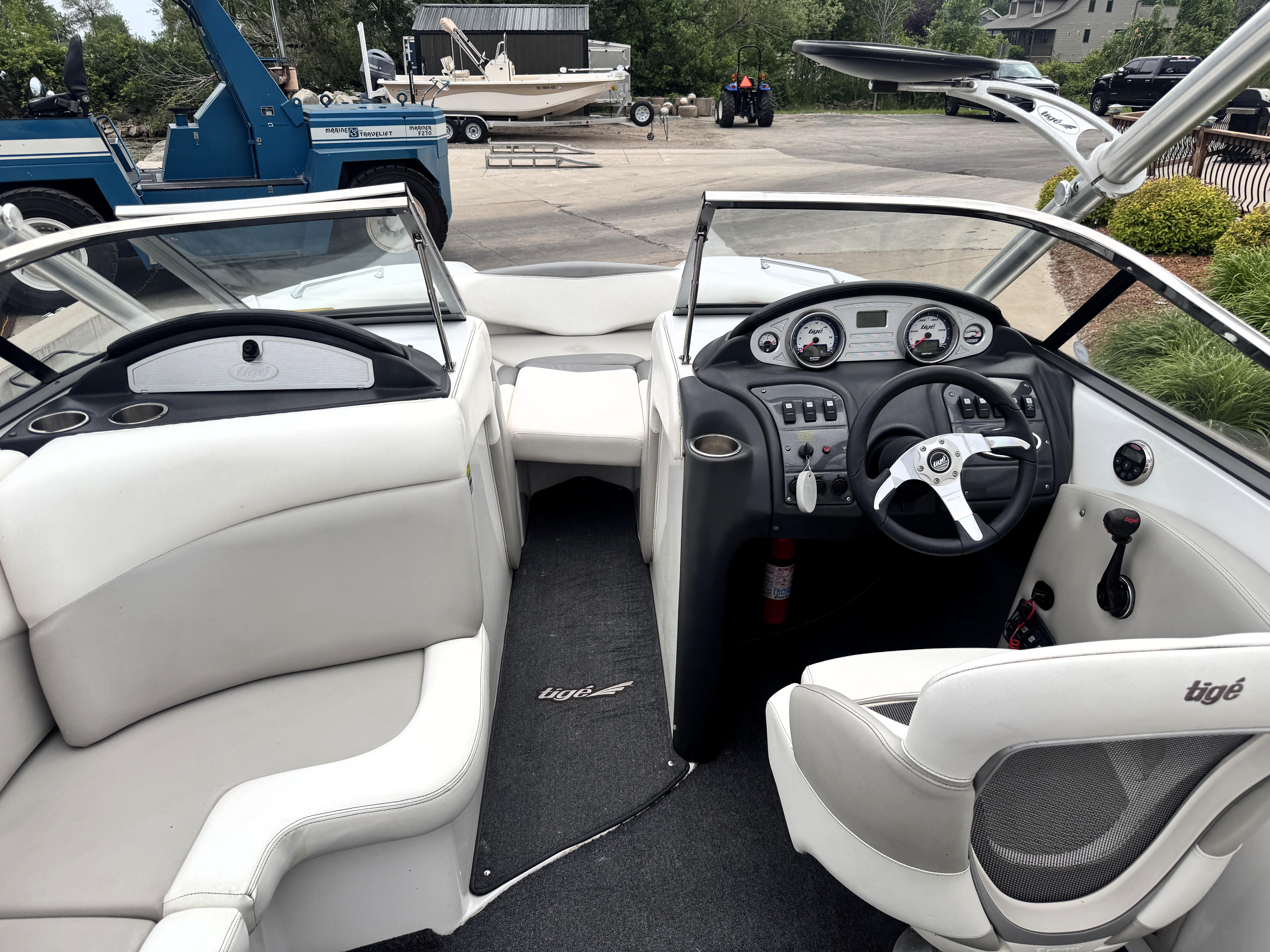 Slide: The Image of 2007 Tigé RZ2 boat interior with white seating and modern dashboard controls. - 20