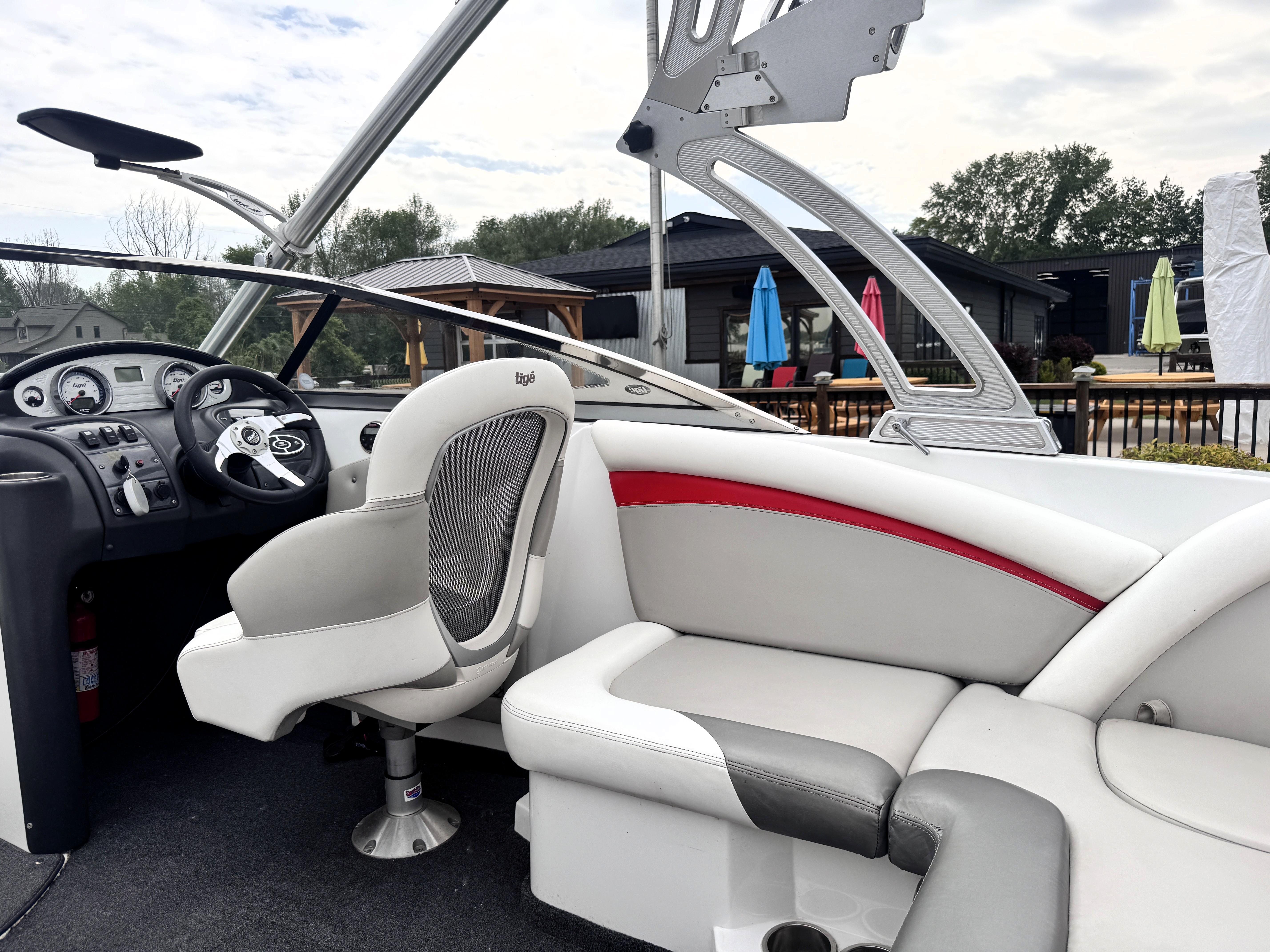 Slide: The Image of 2007 Tigé RZ2 boat interior with steering wheel, seating, and dashboard controls. - 23