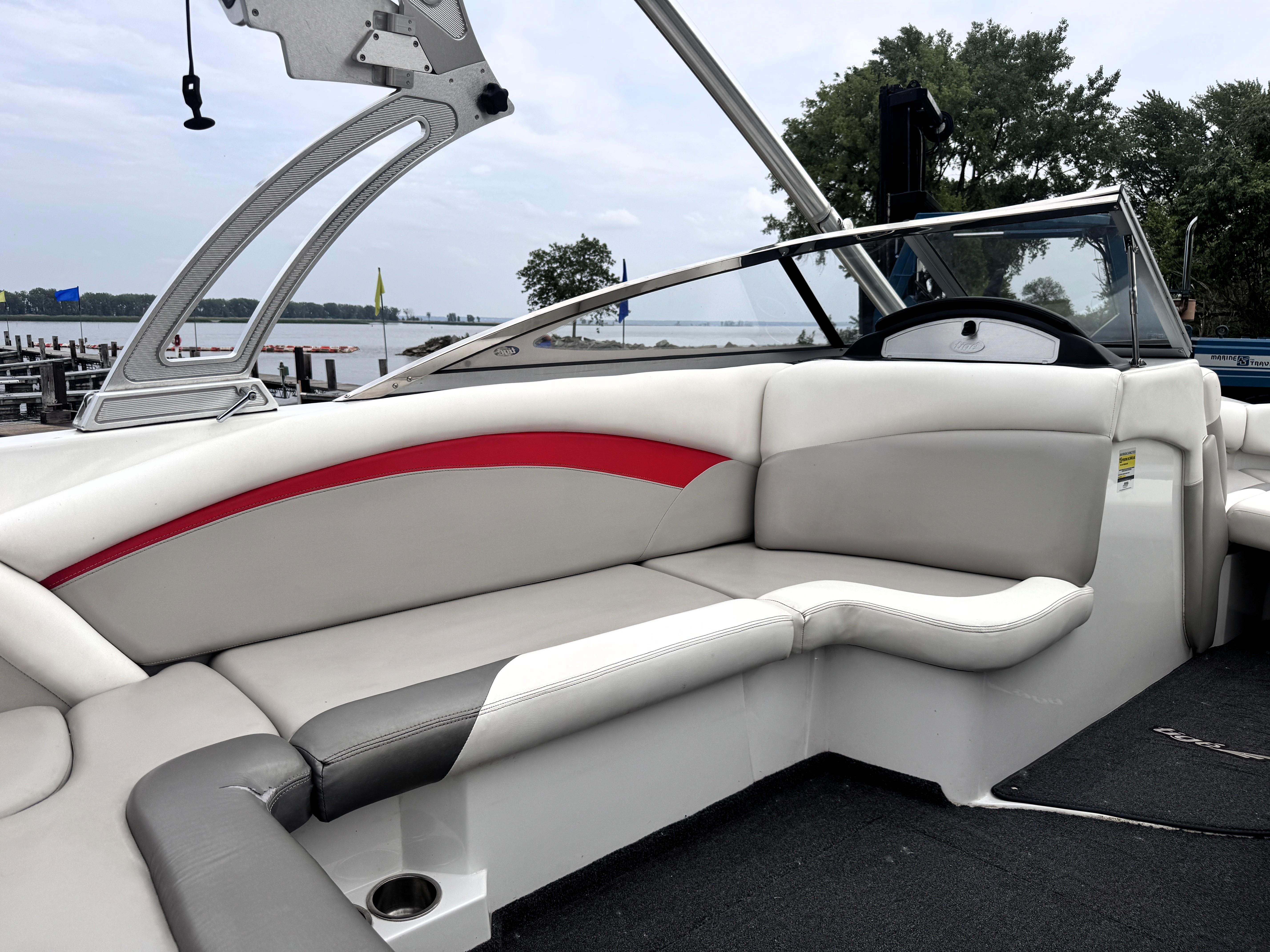 Slide: The Image of 2007 Tigé RZ2 boat interior with white and red seating, lake view in background. - 6