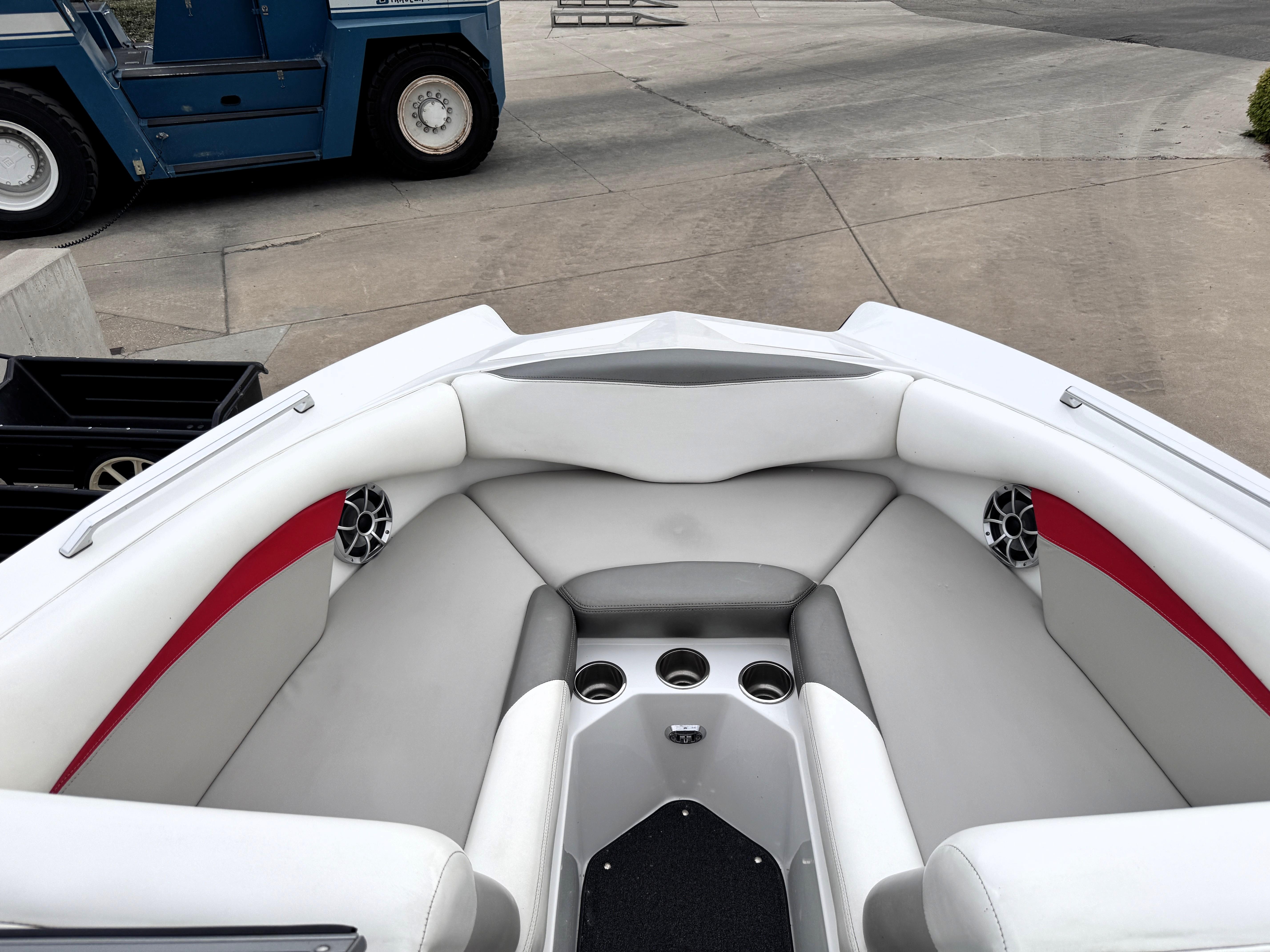 Slide: The Image of 2007 Tigé RZ2 boat interior with white and red seating, cup holders, and speakers. - 8