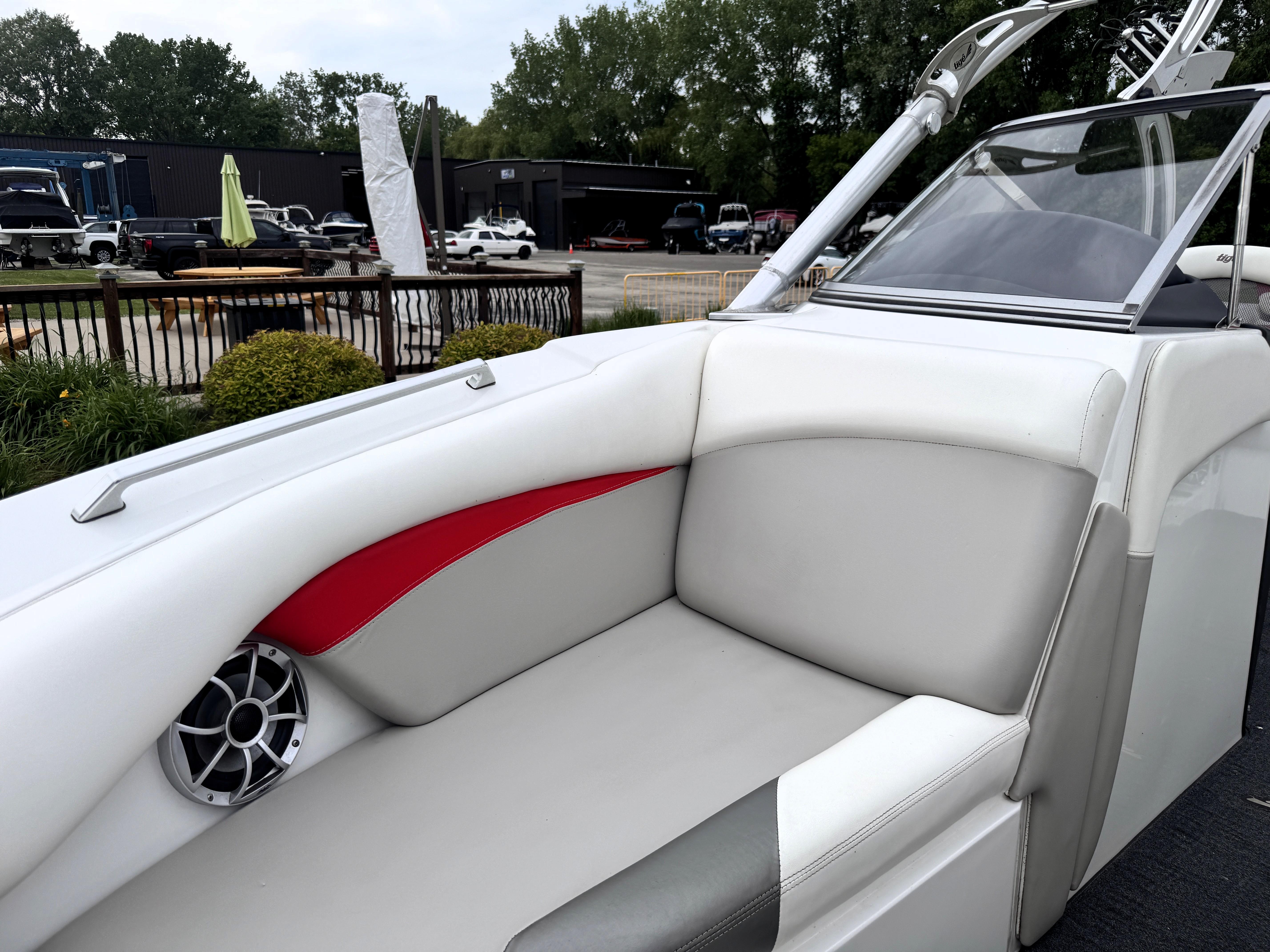 Slide: The Image of 2007 Tigé RZ2 boat interior with white and red seating, speaker, and windshield. - 9