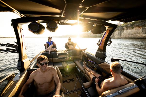 Slide: The Image of 2024 Tigé ULTRA ZX 23 and 25 boat with people enjoying a sunny day on the water. - 16