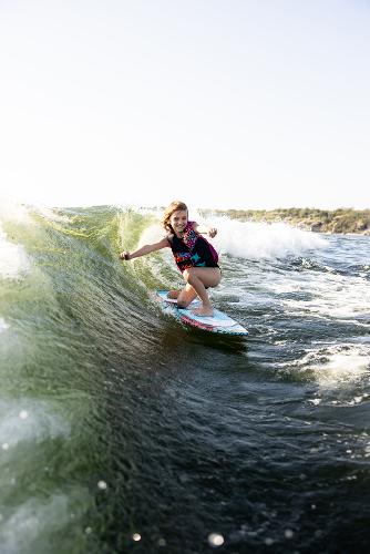 Slide: The Image of Person wakesurfing behind 2024 Tigé ULTRA ZX 23 and 25 boat. - 21