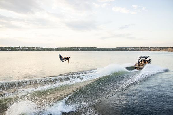 Slide: The Image of 2024 Tigé ULTRA ZX 23 and 25 boat towing a wakeboarder on a lake. - 33