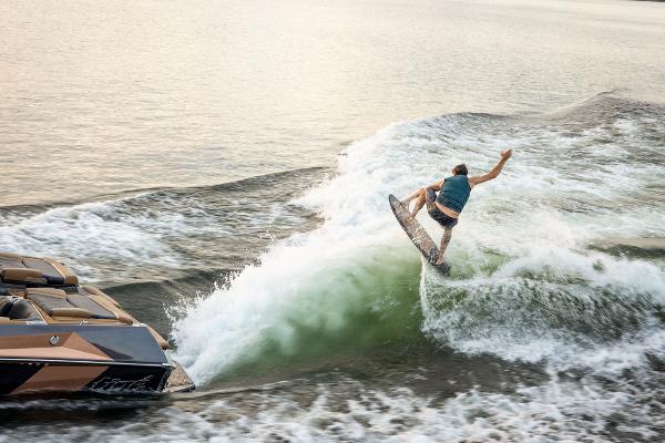 Slide: The Image of 2024 Tigé ULTRA ZX 23 and 25 boat with a wakeboarder performing a trick. - 34