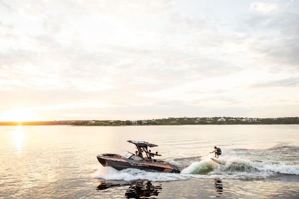 Slide: The Image of 2024 Tigé ULTRA ZX 23 and 25 boat on a lake at sunset with a wakeboarder. - 35