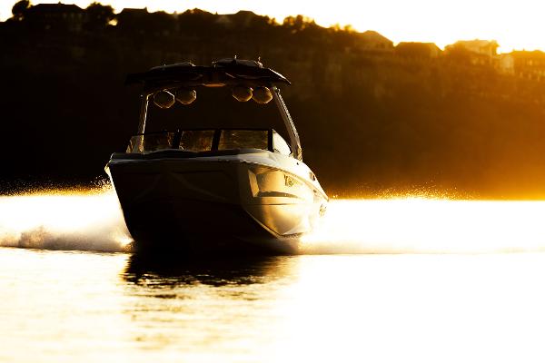 Slide: The Image of 2024 Tigé ULTRA ZX 23 and 25 boat cruising at sunset. - 37