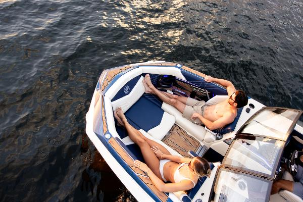 Slide: The Image of 2024 Tigé ULTRA ZX 23 and 25 boat with people relaxing on deck. - 44