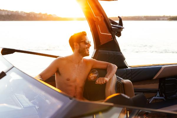 Slide: The Image of Man enjoying sunset on 2024 Tigé ULTRA ZX 23 and 25 boat. - 7