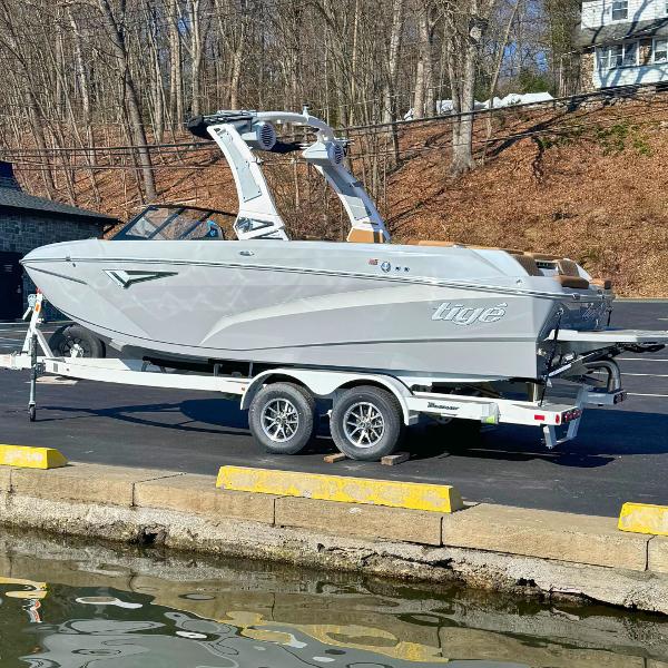 Slide: The Image of 2024 Tigé Z1 boat on a trailer near a dock. - 0