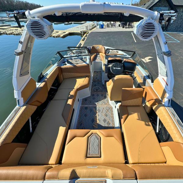 Slide: The Image of 2024 Tigé Z1 boat interior with tan seating and advanced audio system. - 10