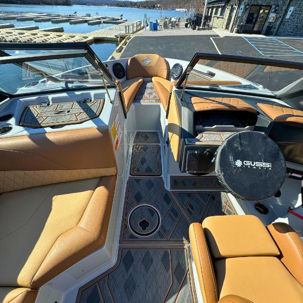 Slide: The Image of 2024 Tigé Z1 boat interior with tan leather seats and modern dashboard. - 11