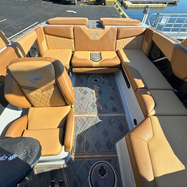 Slide: The Image of 2024 Tigé Z1 boat interior with tan leather seating and diamond-patterned flooring. - 12