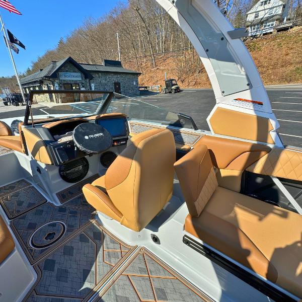 Slide: The Image of 2024 Tigé Z1 boat interior with tan seats and modern dashboard. - 13