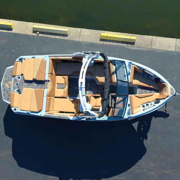 Slide: The Image of 2024 Tigé Z1 boat docked, aerial view showing tan seating and sleek design. - 3