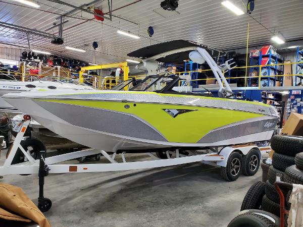 Slide: The Image of 2021 Tigé Z3 boat in a garage, featuring a sleek design with lime green accents. - 0