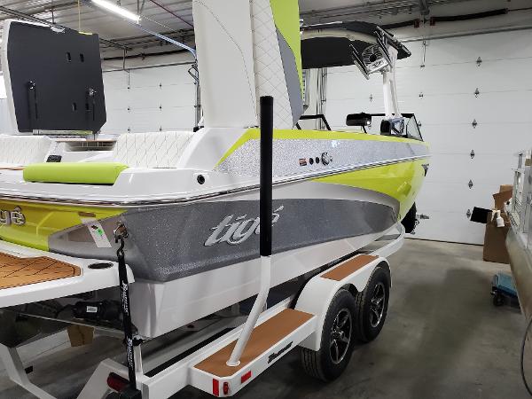 Slide: The Image of 2021 Tigé Z3 boat in a garage, featuring a vibrant lime and gray design. - 1