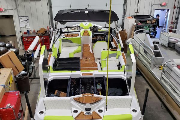 Slide: The Image of 2021 Tigé Z3 boat in a workshop, featuring lime green and white interior. - 10