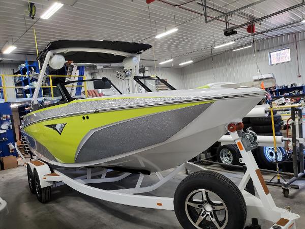 Slide: The Image of 2021 Tigé Z3 boat in a garage, featuring a vibrant yellow and gray design. - 2