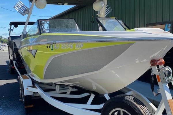 Slide: The Image of 2021 Tigé Z3 boat on trailer, lime green and white, parked outdoors. - 3