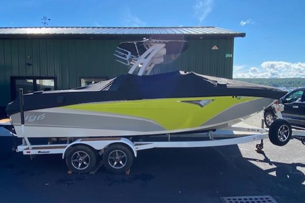 Slide: The Image of 2021 Tigé Z3 boat on trailer, covered, parked outdoors under clear sky. - 4