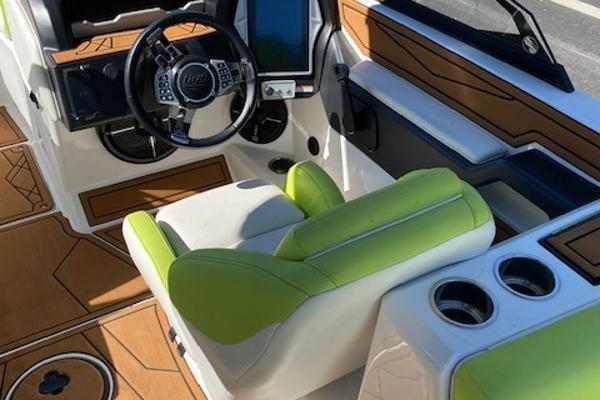 Slide: The Image of 2021 Tigé Z3 boat interior with lime green seating and modern dashboard controls. - 7