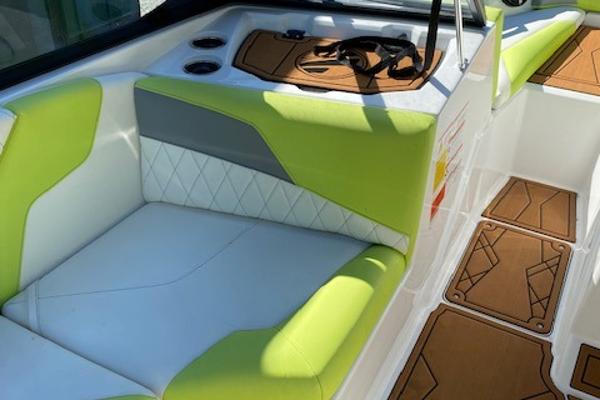 Slide: The Image of 2021 Tigé Z3 boat interior with lime green and white seating, featuring cup holders and stylish flooring. - 9