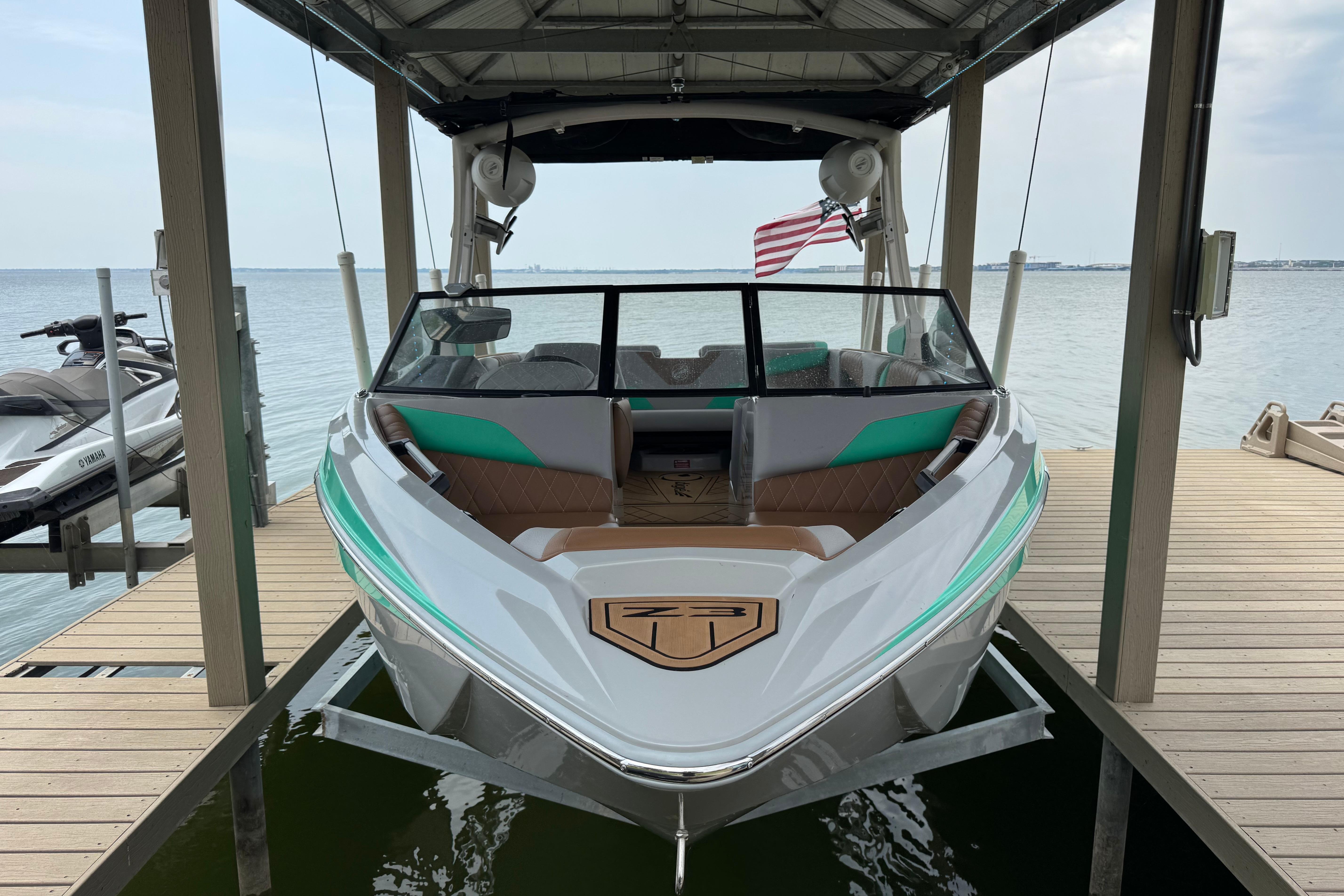 Slide: The Image of 2022 Tigé Z3 boat docked, featuring sleek design and modern amenities. - 3