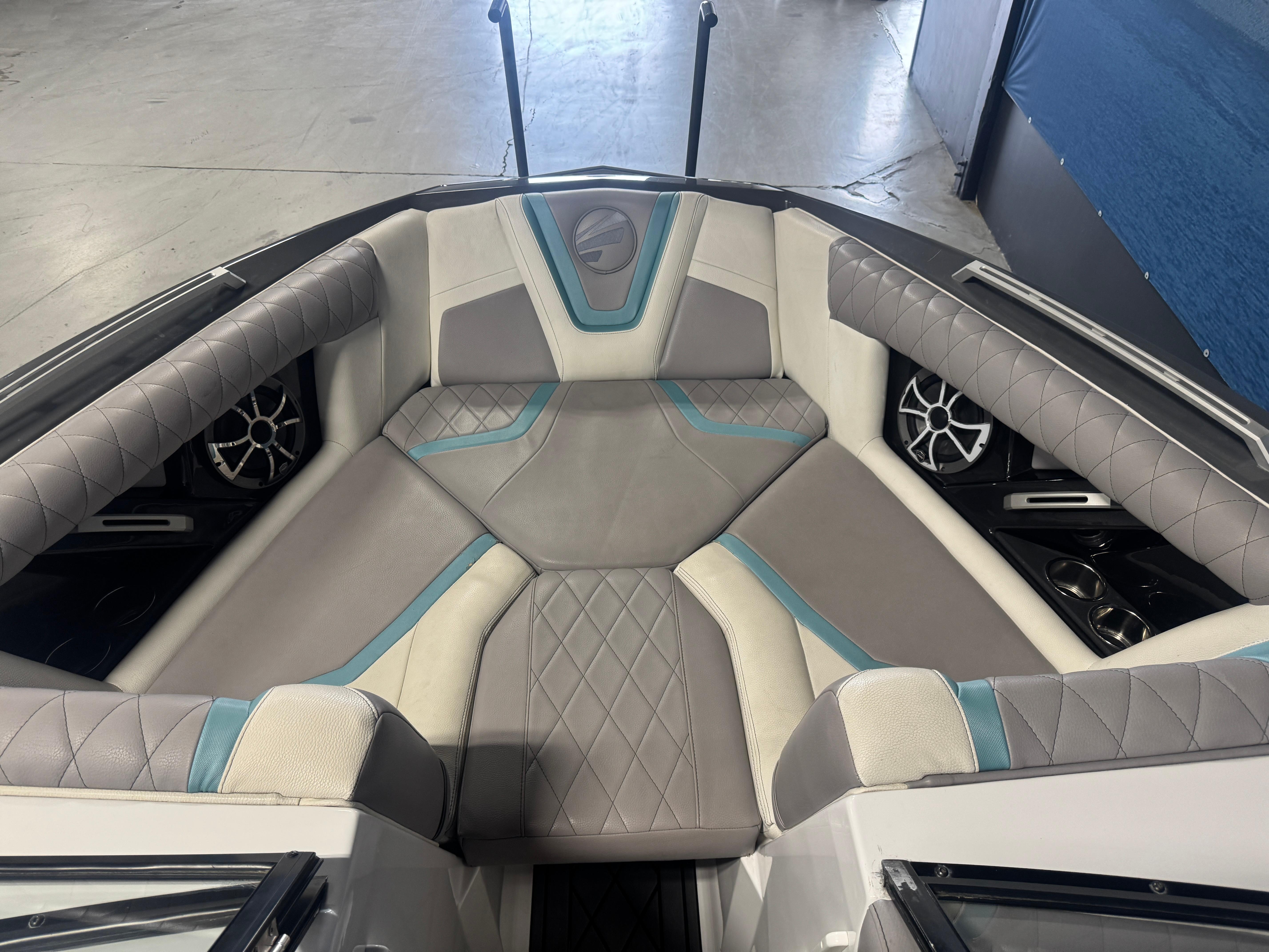 Slide: The Image of 2019 Tigé ZX1 boat interior with gray and teal cushioned seating. - 13