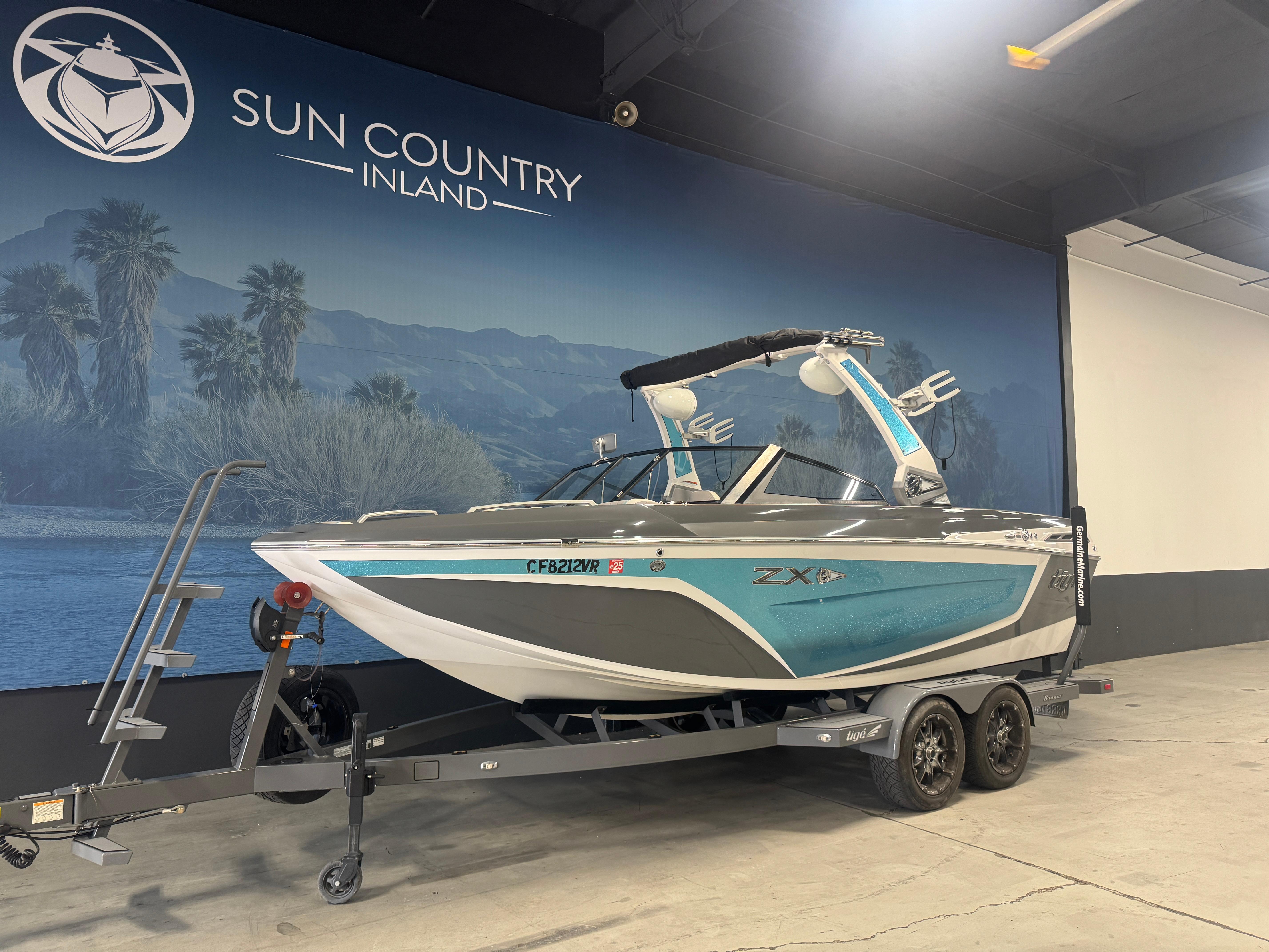 Slide: The Image of 2019 Tigé ZX1 boat on trailer at Sun Country Inland showroom. - 2