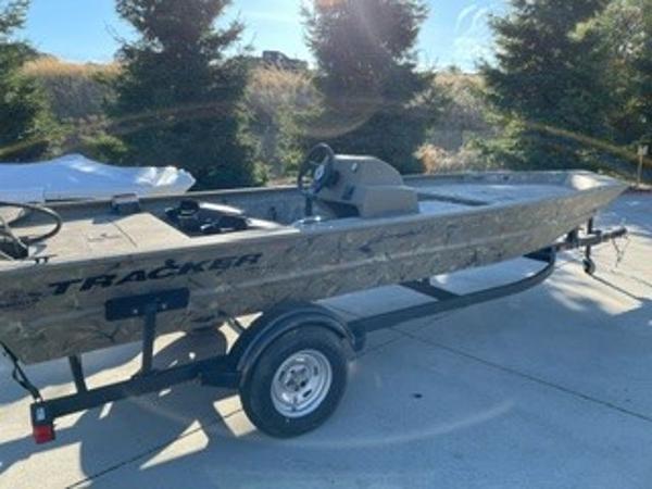 Slide: The Image of 2024 Tracker Grizzly 1754 SC boat on trailer, parked outdoors in sunlight. - 0