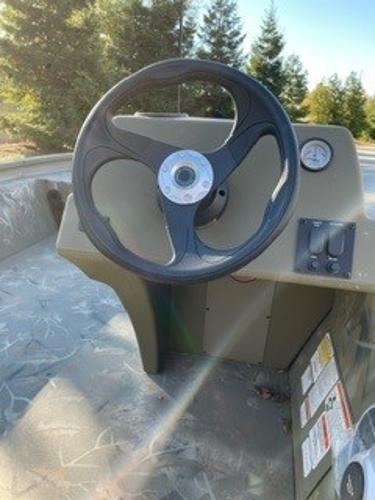 Slide: The Image of 2024 Tracker Grizzly 1754 SC steering wheel and dashboard in a boat. - 1