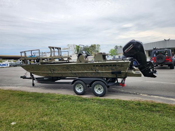 Slide: The Image of 2024 Tracker Grizzly 2072 CC boat on trailer with Mercury outboard motor. - 1