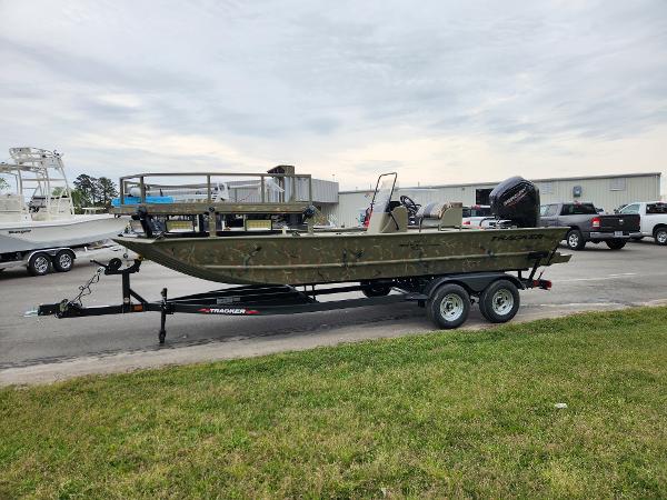 Slide: The Image of 2024 Tracker Grizzly 2072 CC boat on trailer, parked outdoors. - 2