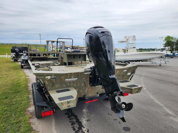 Slide: The Image of 2024 Tracker Grizzly 2072 CC boat with outboard motor on trailer. - 3