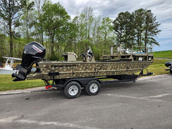 Slide: The Image of 2024 Tracker Grizzly 2072 CC boat with camouflage design on a trailer. - 4