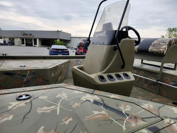Slide: The Image of 2024 Tracker Grizzly 2072 CC boat with camouflage design and center console. - 5