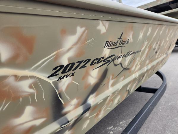 Slide: The Image of 2024 Tracker Grizzly 2072 CC boat with camo design and Blind Duck branding. - 6