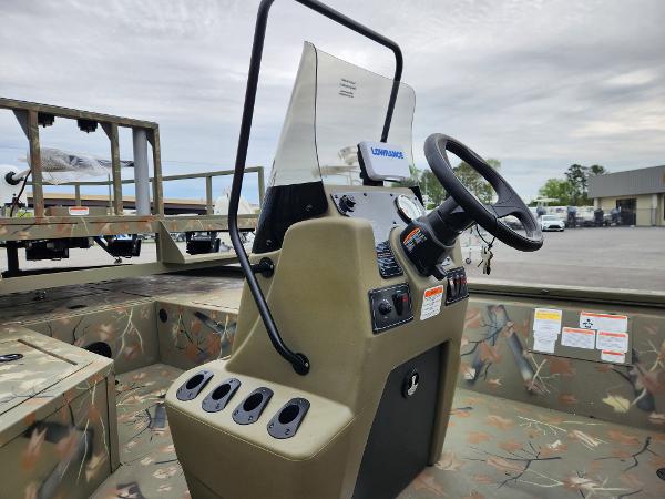 Slide: The Image of 2024 Tracker Grizzly 2072 CC center console boat interior with steering wheel and controls. - 7