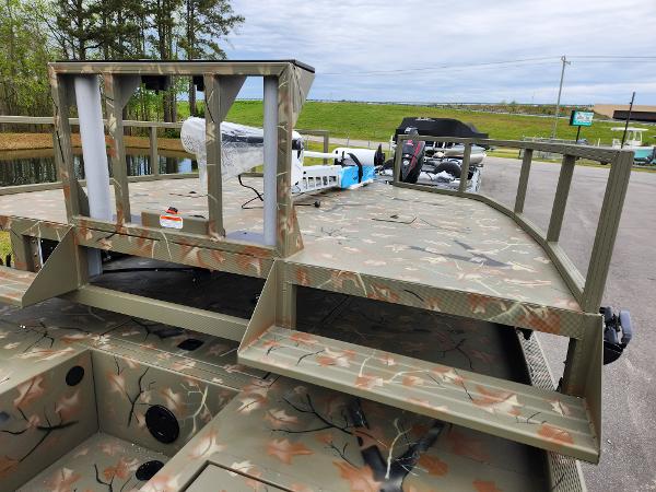 Slide: The Image of 2024 Tracker Grizzly 2072 CC camo fishing boat at dock. - 8