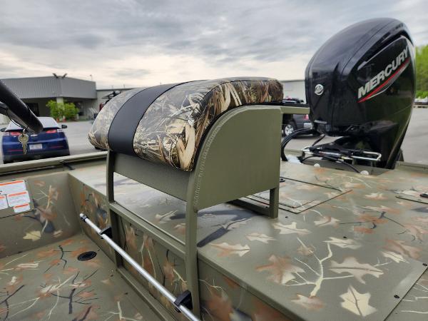 Slide: The Image of 2024 Tracker Grizzly 2072 CC boat with camo seating and Mercury outboard motor. - 9