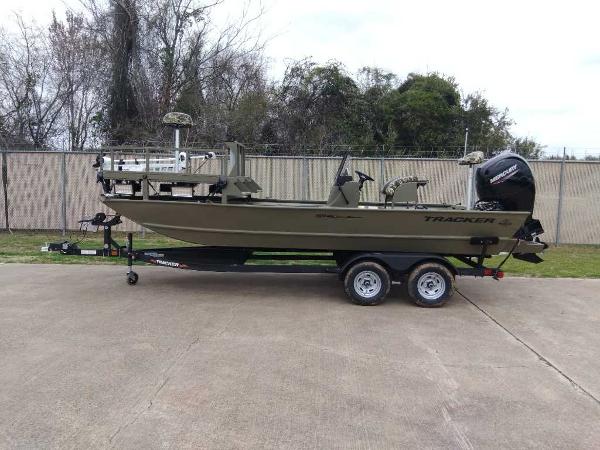 Slide: The Image of 2024 Tracker Grizzly 2072 CC Sportsman boat on trailer, side view. - 0