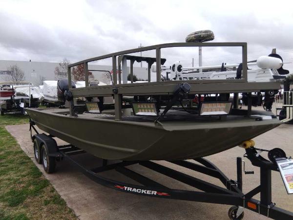Slide: The Image of 2024 Tracker Grizzly 2072 CC Sportsman boat on trailer, outdoor display. - 2