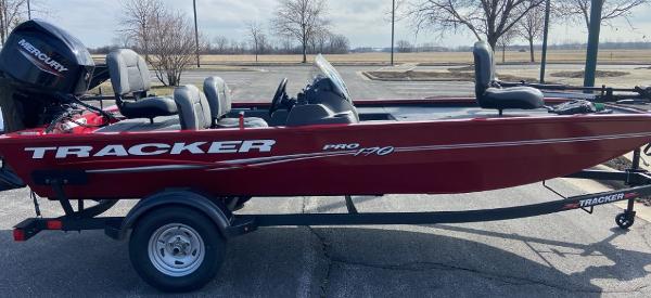 Slide: The Image of 2024 Tracker Pro 170 fishing boat in red on a trailer. - 0