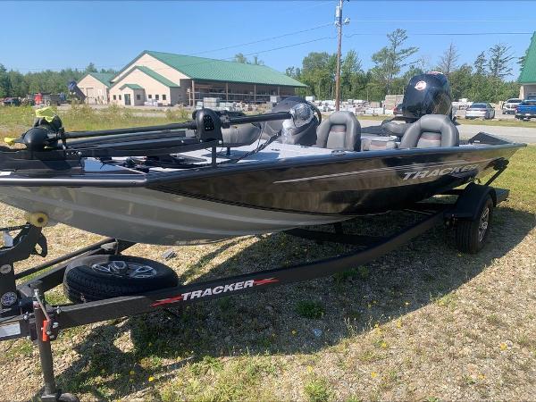 Slide: The Image of 2024 Tracker PT 195 XTE fishing boat on trailer in outdoor setting. - 1