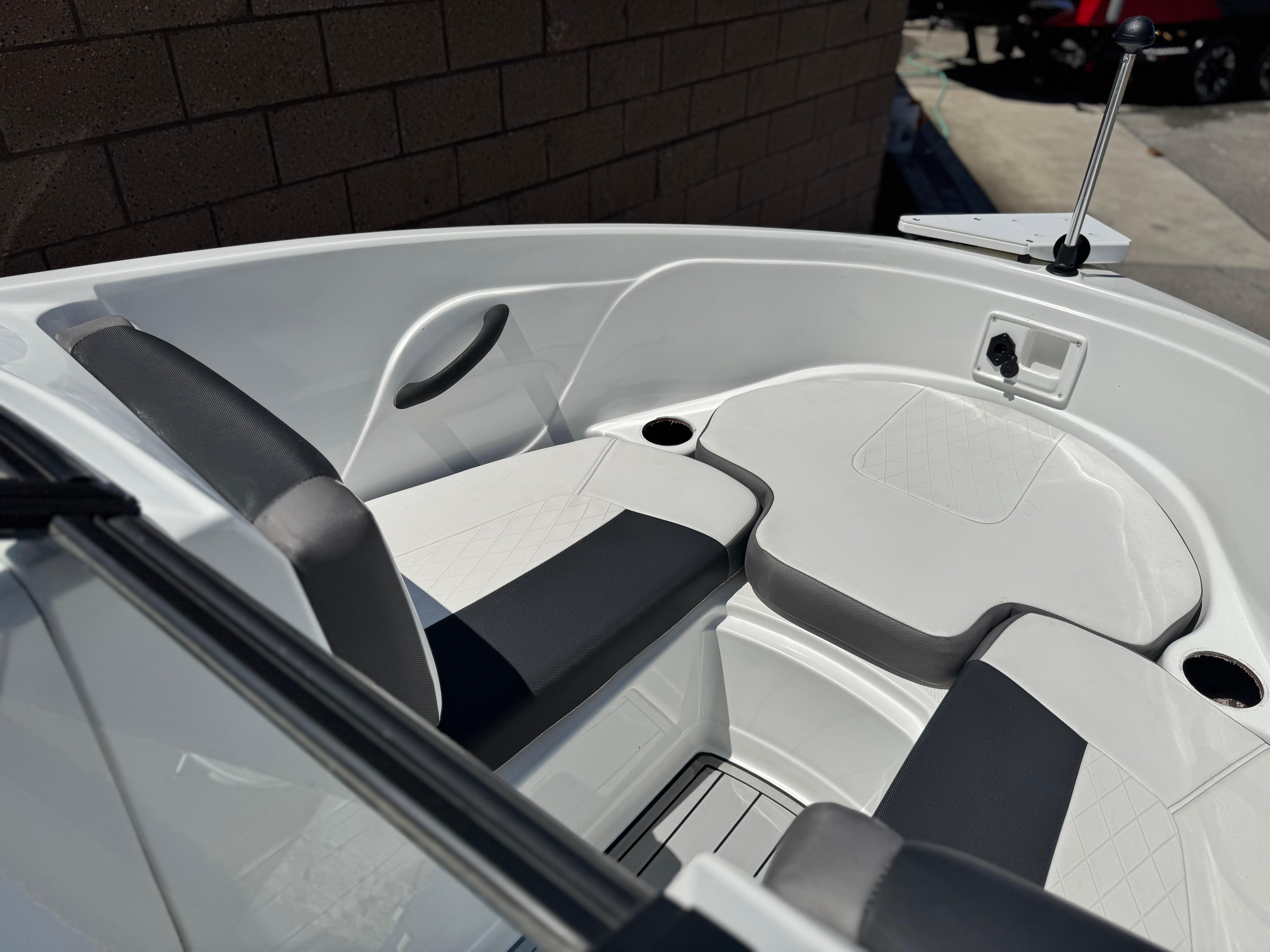Slide: The Image of 2019 Tracker Tahoe 450 TF boat interior with cushioned seating and cup holders. - 10