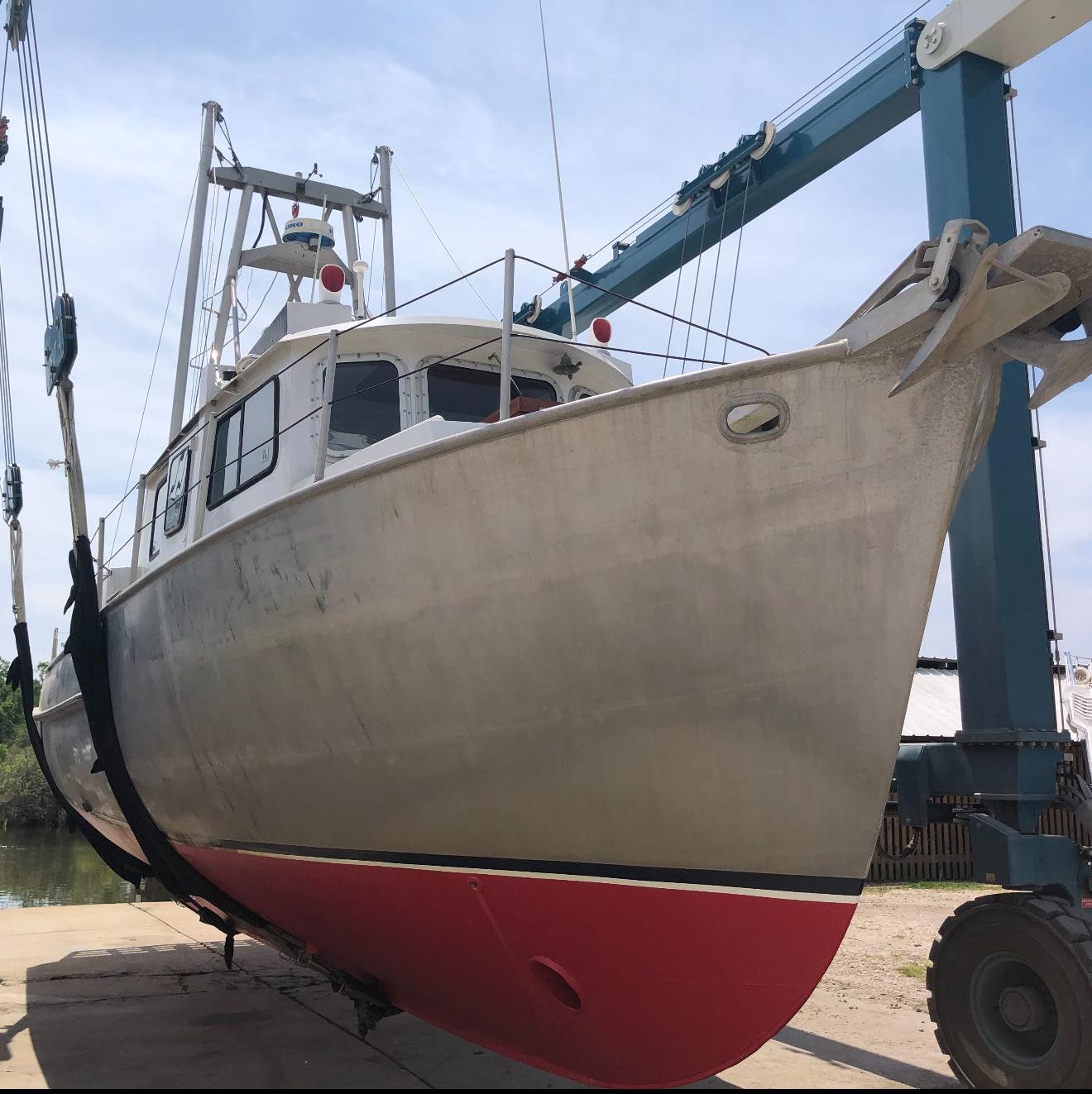 Slide: The Image of 1991 Trawler 38 boat on lift, showcasing hull and deck details. - 37
